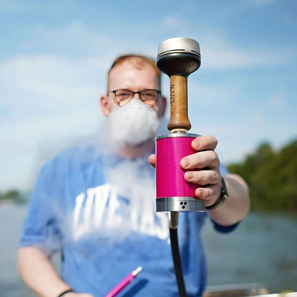 Person using VYRO-One Carbon Pink Hookah outdoors